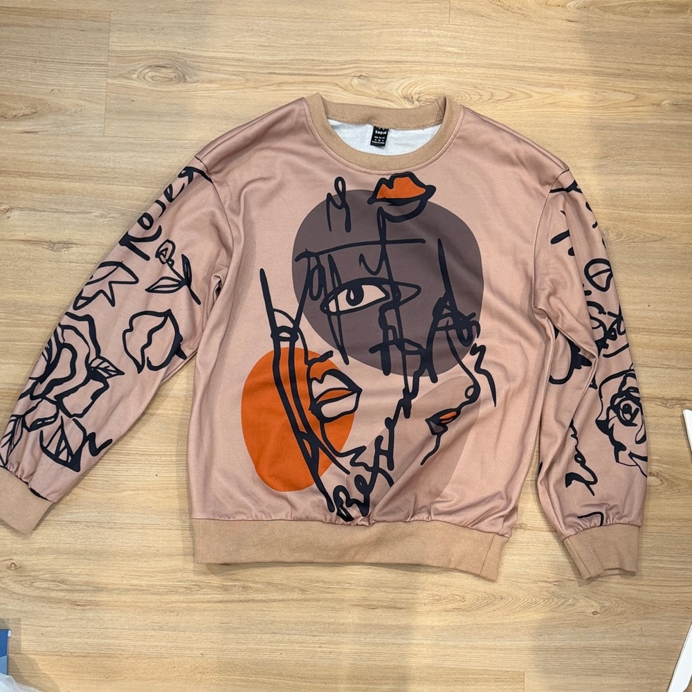 SHEIN Blush Pink Graphic Sweatshirt with Black & Orange Artwork
